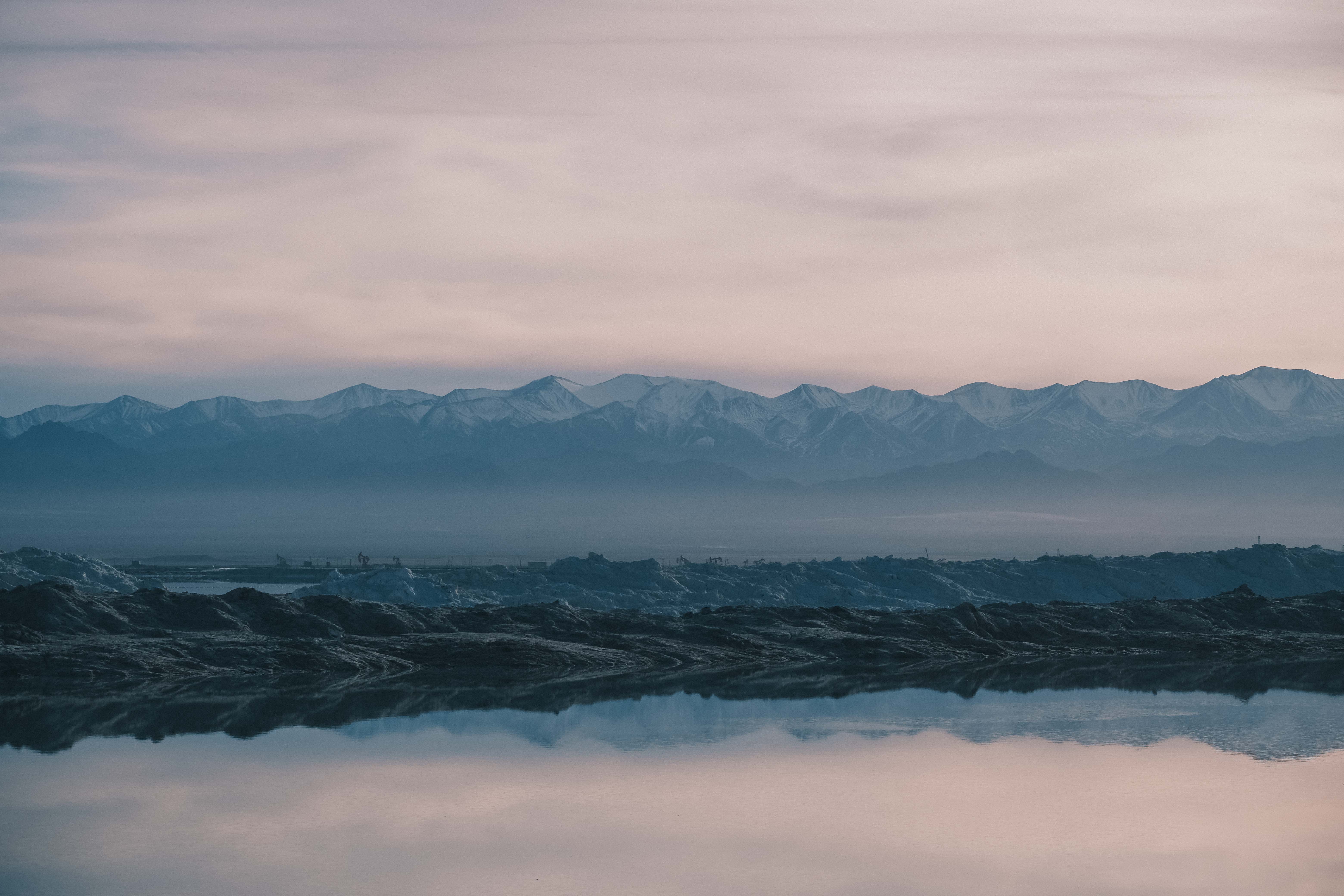 Layers of salt deposits reflected in water