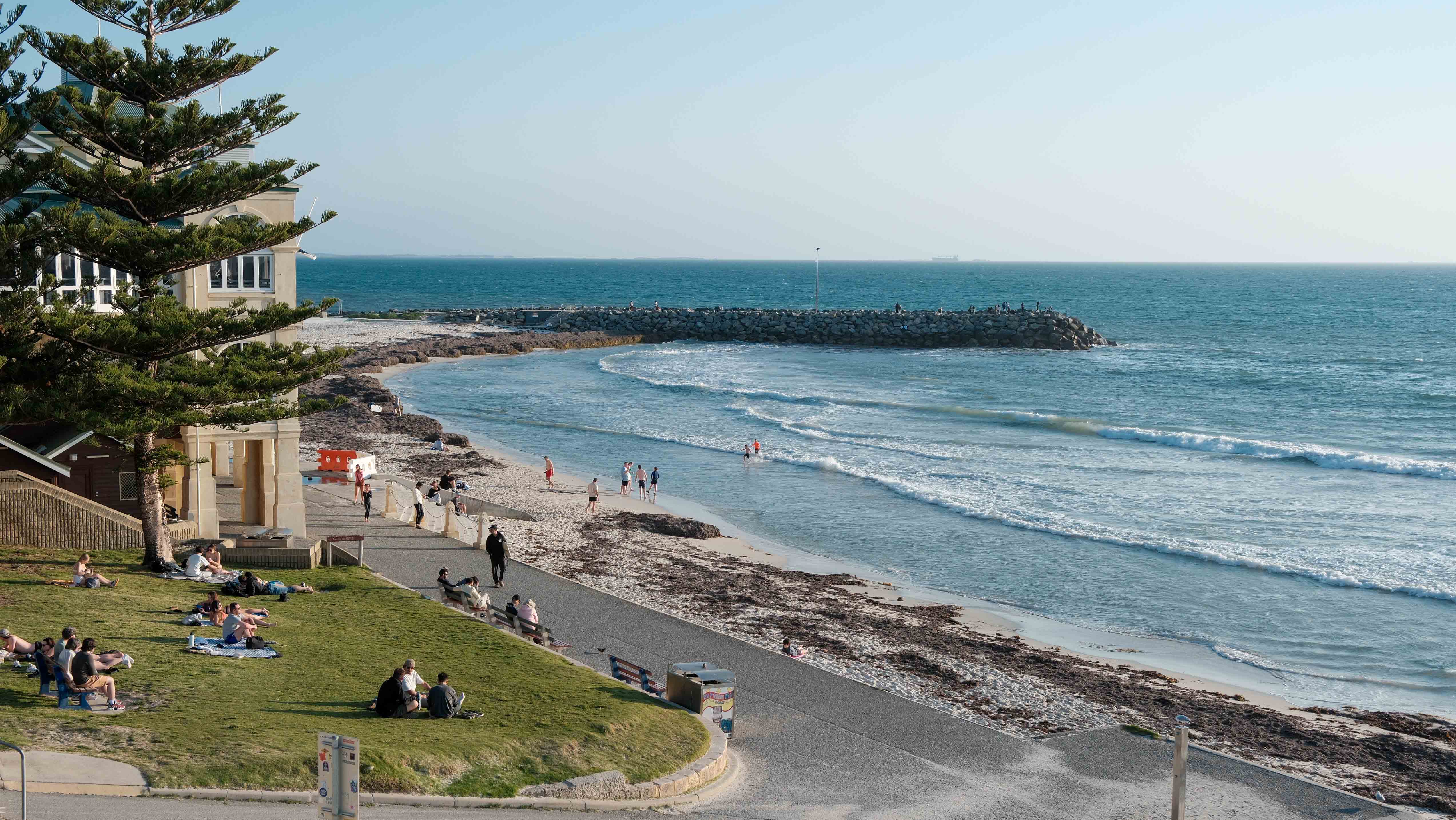 People relaxing and walking beside the sea at Cottesloe Beach