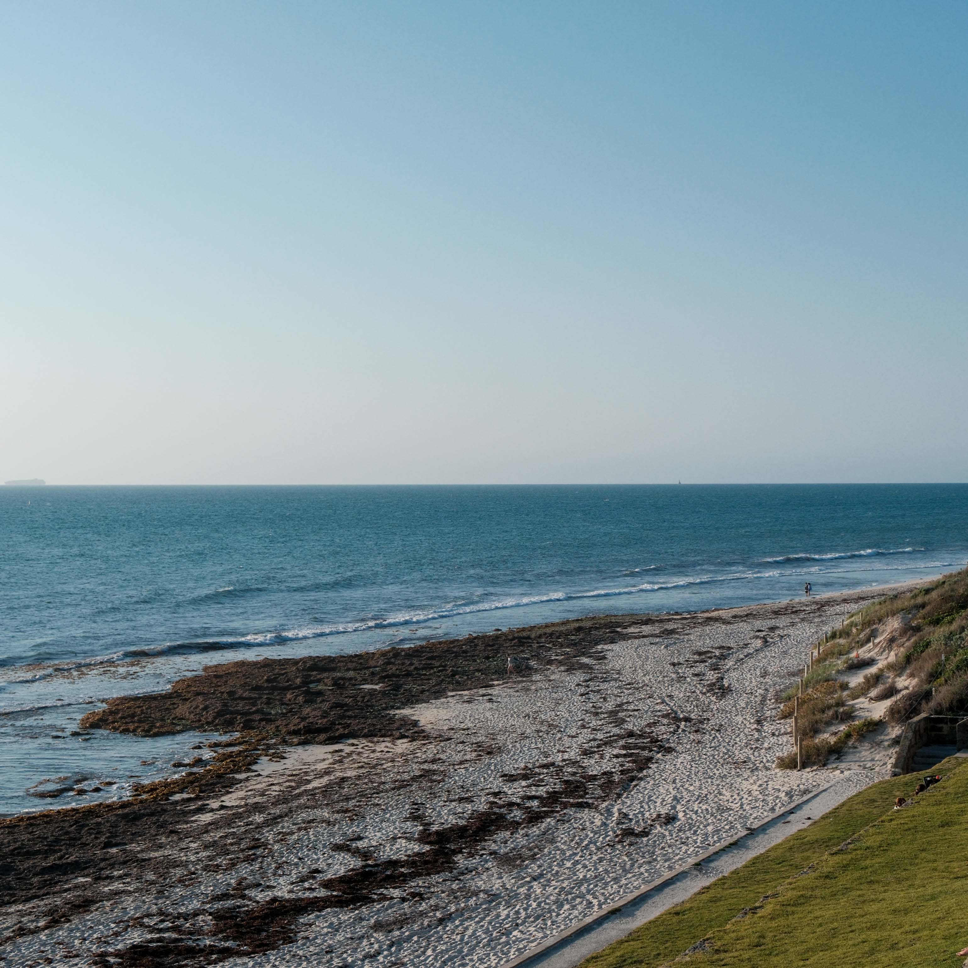 A long stretch of beach beneath an open sky