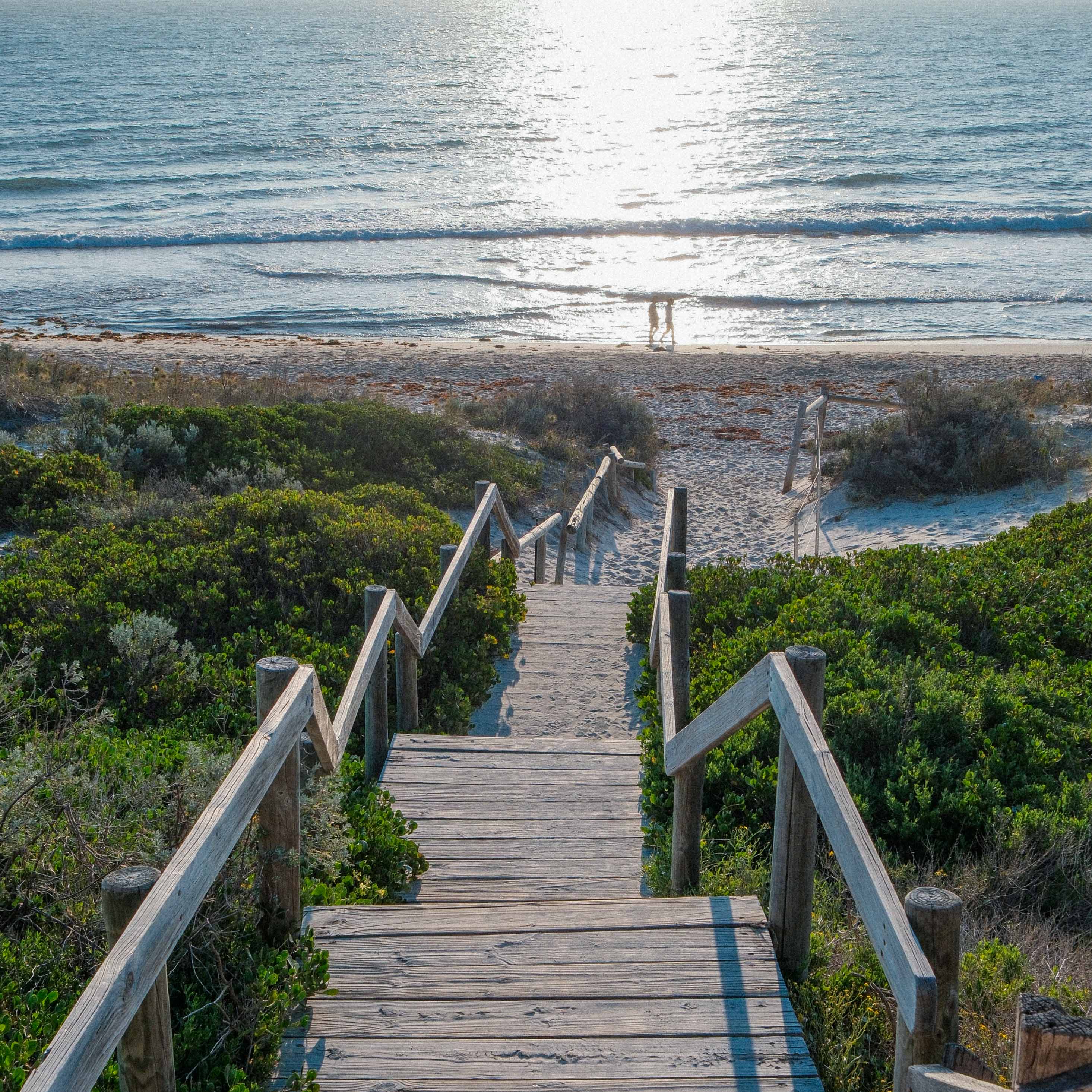 A wooden stairway leading down to the beach