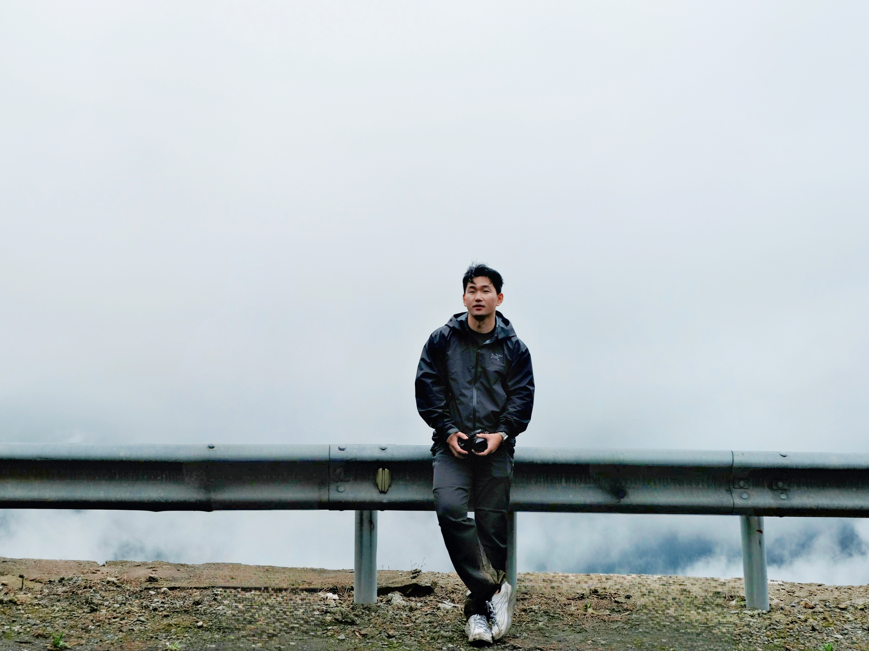 Portrait of photographer Eric beside a foggy mountain road
